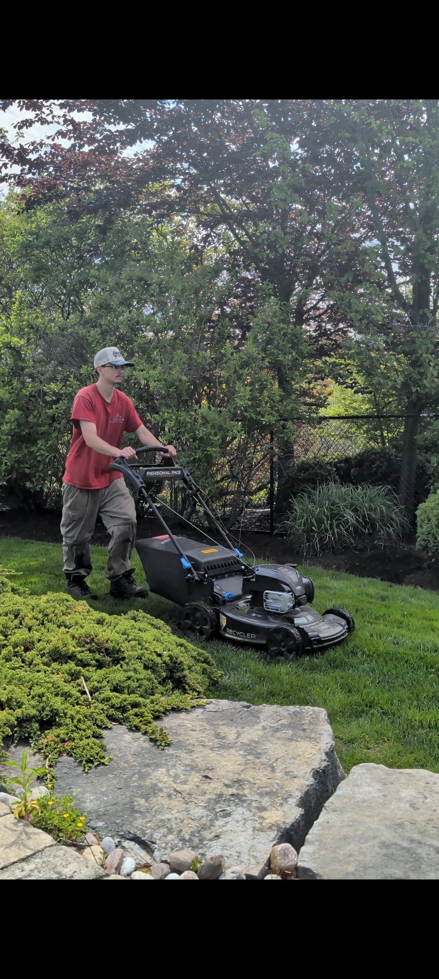 Crew member push-mowing a lawn in Durham Region