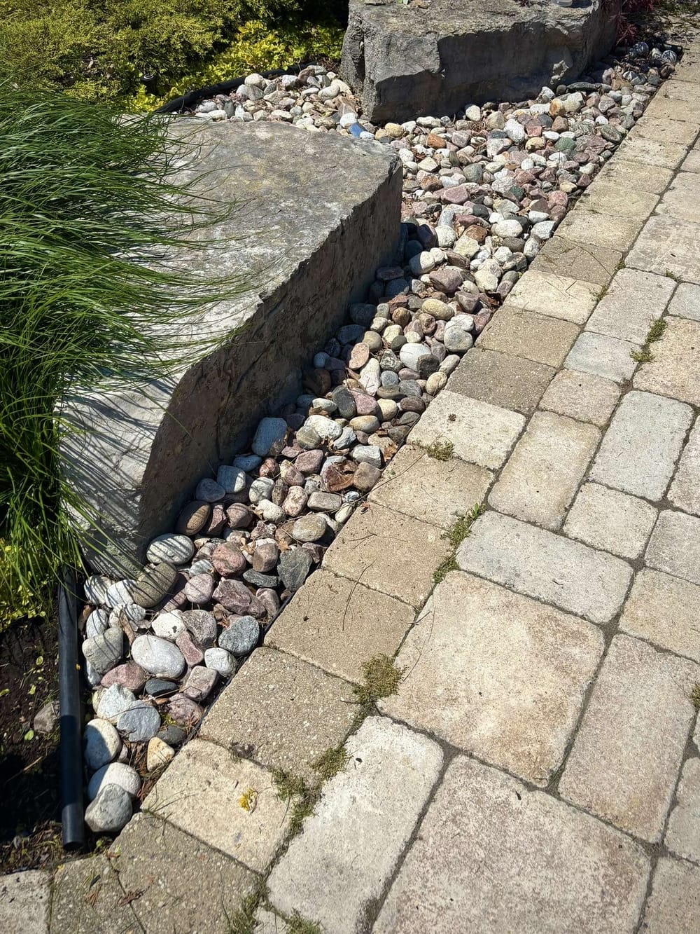 After: River rock bed weeded and cleaned