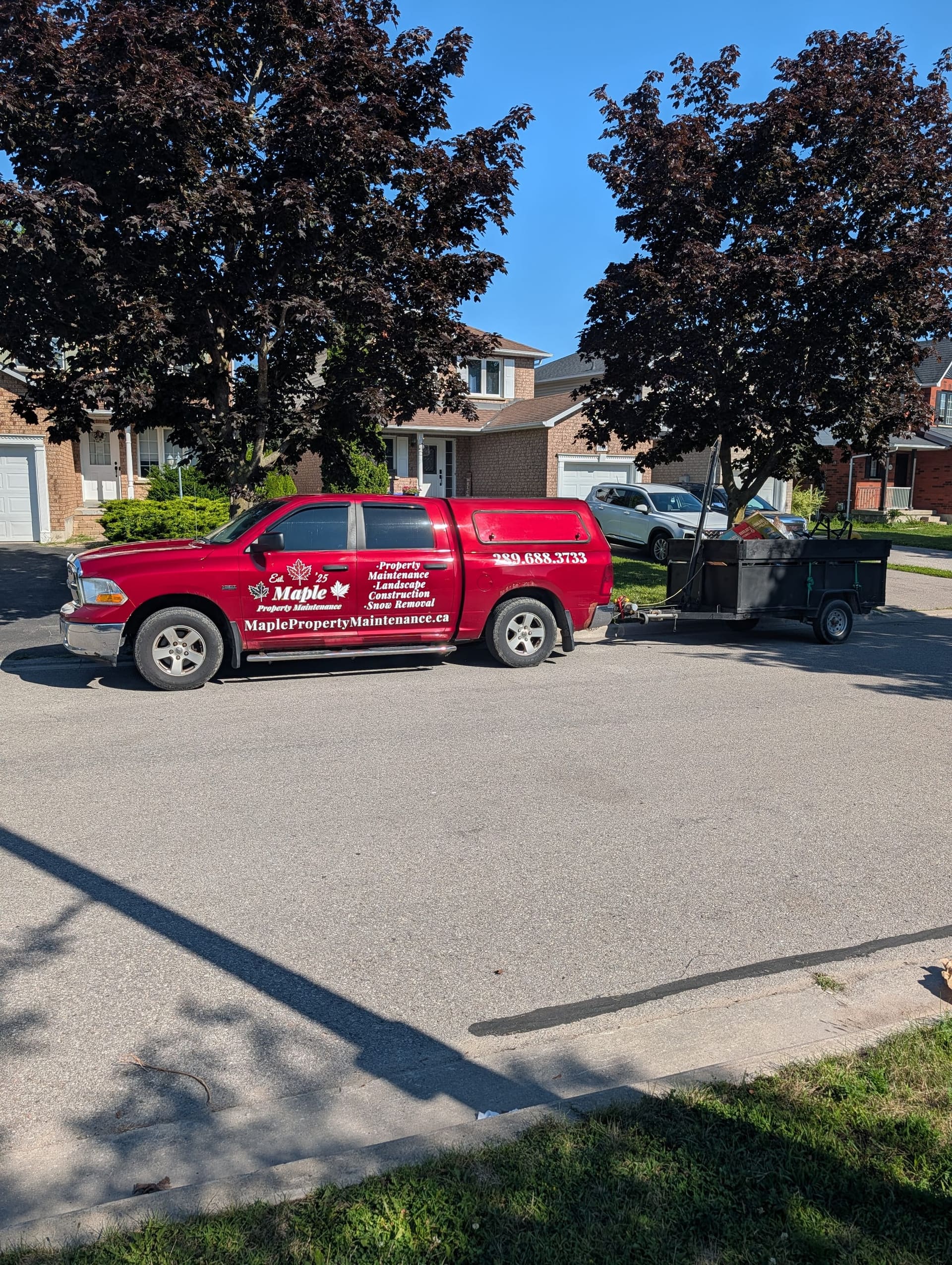 Maple Property Maintenance truck and trailer on a residential street in Durham Region